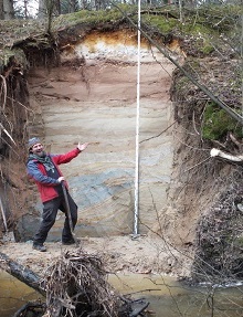 A man with a shovel at a geological profile
