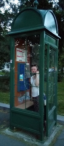Woman calling from a phone booth