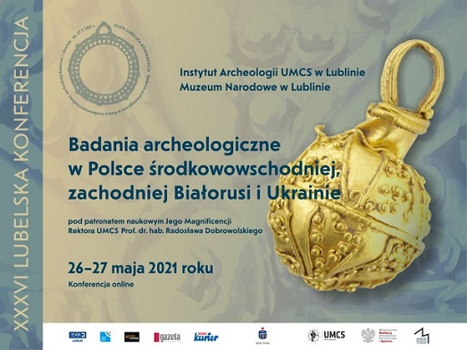 A poster promoting the conference, artifacts in the background
